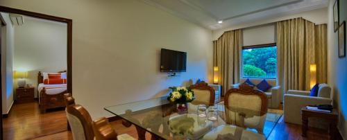 a living room with a dining table and a living room at Clarks Khajuraho in Khajurāho