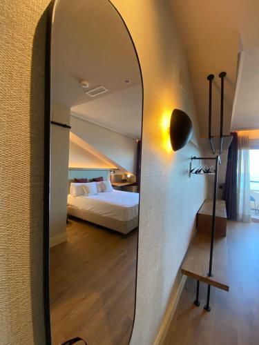 a mirror in a hotel room with a bed at JovA Hotel Boutique in El Campello