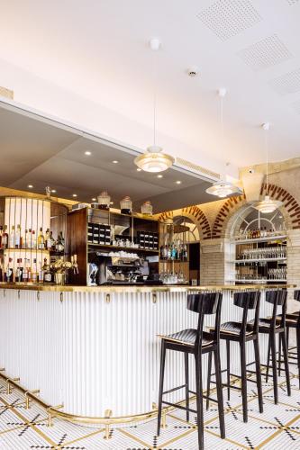 un bar dans un restaurant avec des tabourets dans l'établissement Villa Mirasol, à Mont-de-Marsan