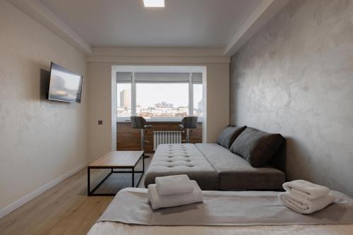 a living room with a couch and a table at CityApartments Kyiv Obolon in Kyiv