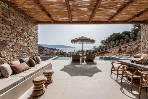 a villa with a swimming pool and a patio at Pera Perou unspoiled luxury villas in Ayia Evfimia