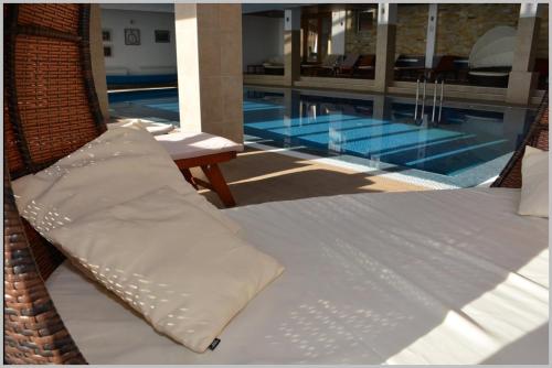 a bed with a pillow next to a swimming pool at Milmari Lux N8 in Kopaonik