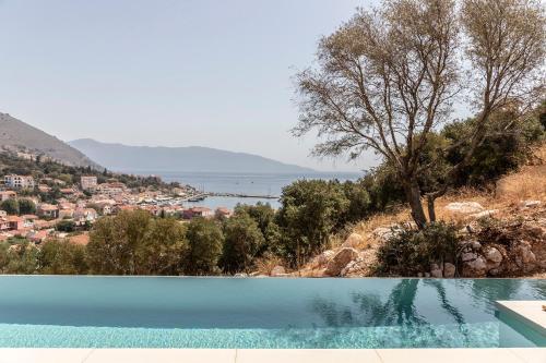 a swimming pool with a view of the water at Pera Perou unspoiled luxury villas in Ayia Evfimia