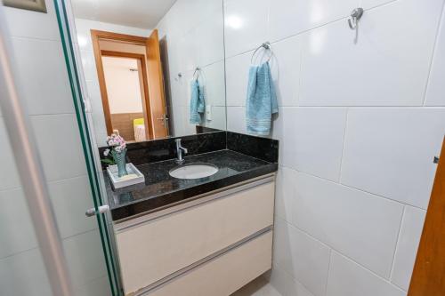 a bathroom with a sink and a mirror at PÉ NA AREIA - 2 qt - 2 WC - PISCINA - wifi - garagem privativa in João Pessoa
