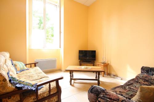 a living room with a couch and a table at La Chaussée de l'Etang in Marcenay