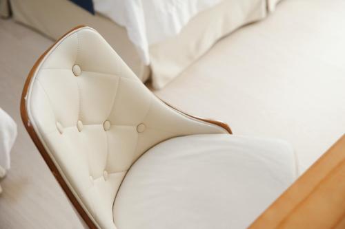 a close up view of a white bed with a white pillow at Miruku Homestay in Taitung City