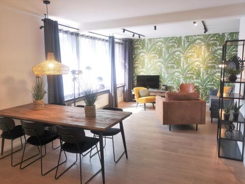 a living room with a dining table and a couch at DBO81 Spacious apartment in the center and beach nearby in Domburg