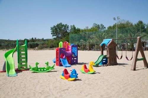 a playground on a beach with toys in the sand at Garden Hotel Ripa in Vieste