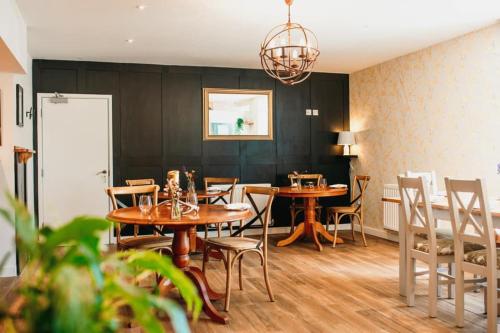 a dining room with wooden tables and chairs at JT Abergwaun hotel in Fishguard