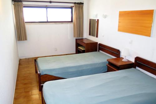 a room with two beds and a window at BEACH FLAT COSTA DA CAPARICA in Costa da Caparica