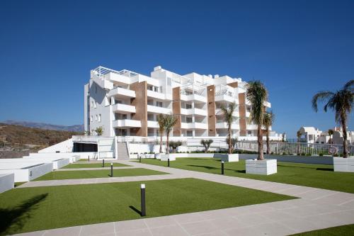 a rendering of a building with a lawn and palm trees at SUNNY BEACH APARTMENT IN CALACEITE in Torrox Costa
