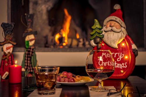 a table with a glass of wine and a christmas ornament at Euphoria Club Hotel in Borovets