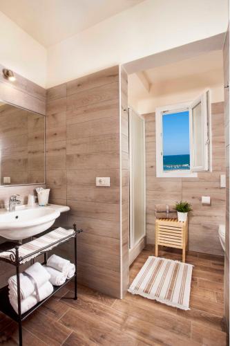 a bathroom with a sink and a mirror at Hotel Sayonara in Cattolica