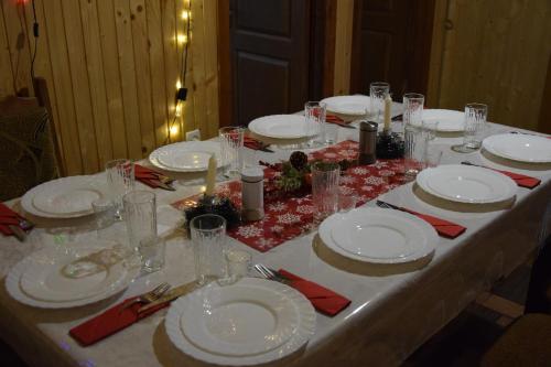 a table with white plates and glasses on it at Svitlyachok in Yaremche