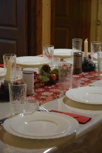 a table with white plates and glasses on it at Svitlyachok in Yaremche