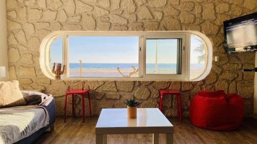 a living room with a window with a view of the beach at "Méditerranée" Salon vue mer au coeur de la ville 10m de la plage in Canet-en-Roussillon