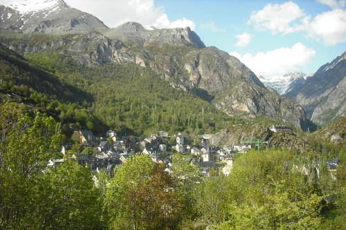 a town in a valley with mountains in the background at Pensión Panticosa in Panticosa