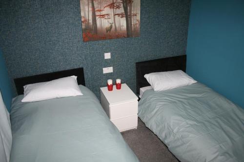 two beds sitting next to each other in a bedroom at White Rose Hotel and Restaurant in Leeds