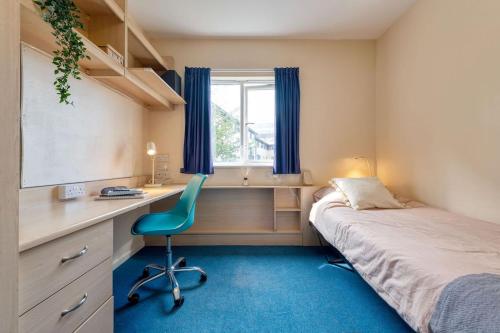 a bedroom with a bed and a desk and a chair at For Students Only Private Bedrooms with Shared Kitchen at Shaftesbury Hall in the heart of Cheltenham in Cheltenham