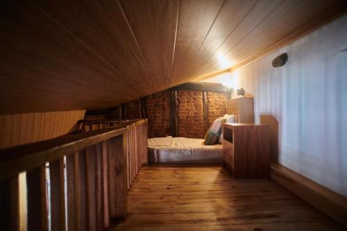 a small room with a bed in a log cabin at Casa da Praça Velha Guest House in Braga