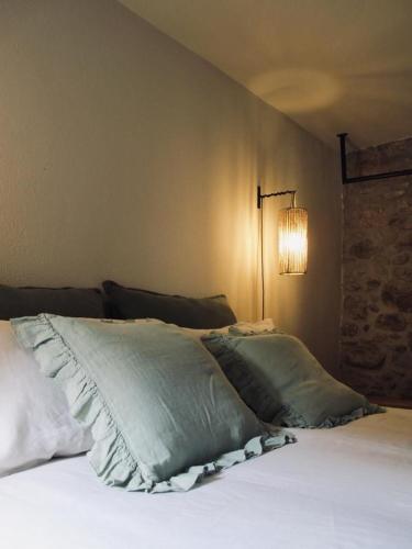 a bedroom with a bed with a light on the wall at CAN SAFRA in La Pera