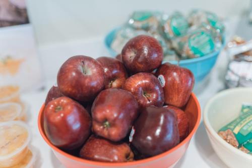 an orange bowl of apples sitting on a table at Equus Inn I75 in Ocala