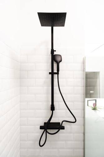 a shower head in a bathroom with a black light at 4-Zi Urban Design 120m² BRANDNEW 200Mbit in Berlin