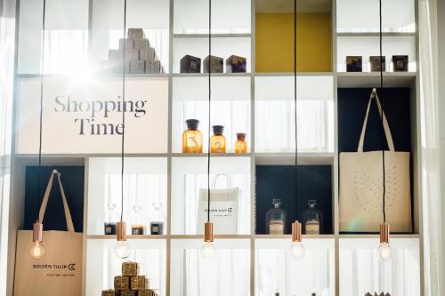 a display case in a store with bottles and bags at Golden Tulip Marseille Euromed in Marseille