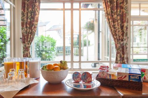 a table with a bowl of fruit and a bowl of juice at Heart of England, Northampton by Marston's Inns in Daventry