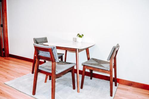 a dining room table with two chairs and a white table and chairs at Renovated building in the heart of Rapid City! in Rapid City