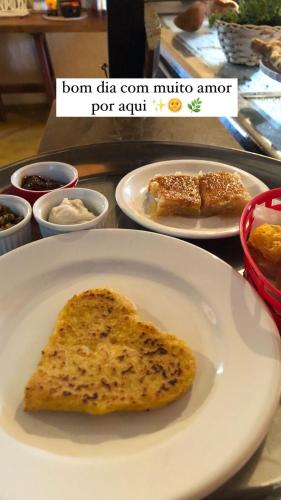 a piece of bread on a plate on a table at Topo do Cipó Ecopousada Vegana in Serra do Cipo