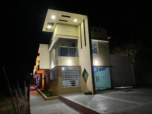 a large house at night with lights on it at Lomas Hotel in San José de Ocoa