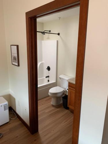a bathroom with a white toilet and a mirror at Stylish ground level apartment close to everything in Rapid City