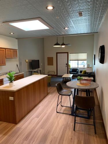 an office with a kitchen and a table and chairs at Stylish ground level apartment close to everything in Rapid City