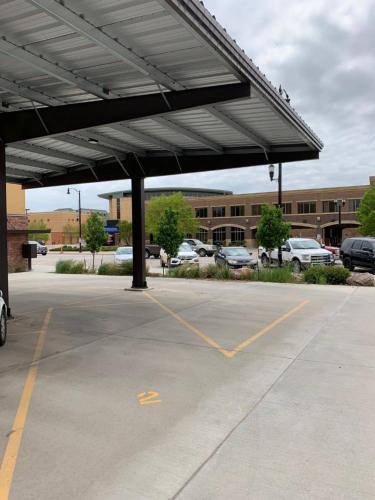 a parking lot with awning in front of a building at Stylish ground level apartment close to everything in Rapid City