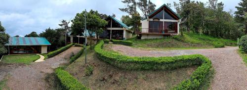 a house on top of a hill with a house at Green Forest Rustic Houses in Monteverde Costa Rica