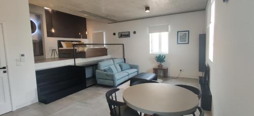 a small living room with a table and a chair at Prime Fully Equipped Studio 4 Ideal Base to Explore Malta in Il-Furjana