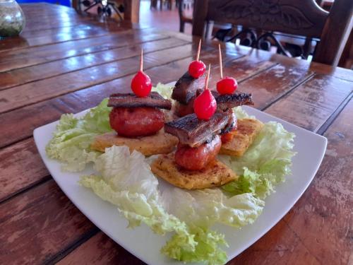 a plate of food with meat on top of lettuce at Hotel Las Rocas Resort Villanueva in Villanueva