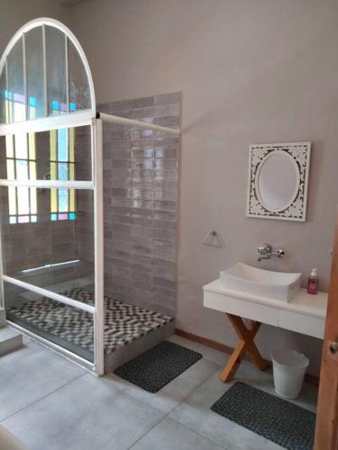 a bathroom with a shower and a sink at Via the Grapevine 3 bedroom house private parking in Colesberg