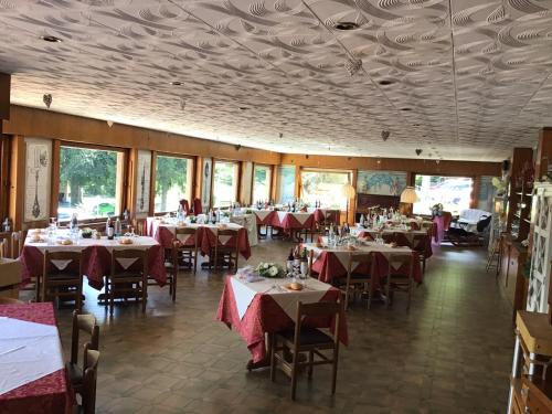 a dining room with tables with red tablecloths at LOCANDA MIRABEAU in Bellagio