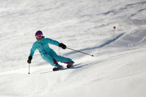 a person is skiing down a snow covered slope at Pension Tirol in Nauders