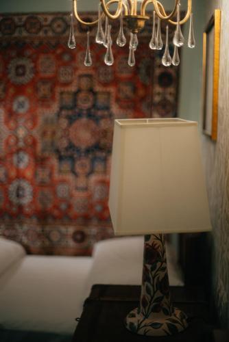 a lamp sitting on a table in a living room at Ati Ambavi Botique Hotel Gudauri in Gudauri