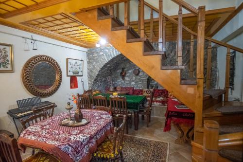 a dining room with a table and a staircase at Casa Lanoi in Syrrako