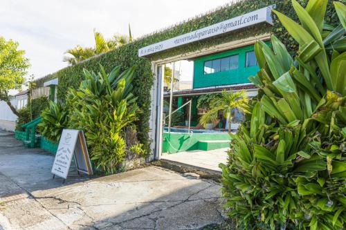 a doorway to a building with a sign and plants at Taverna do Paraiso in Janga