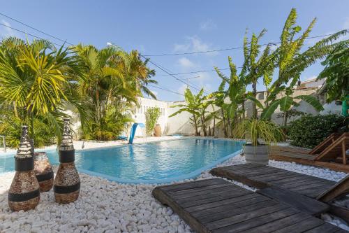 a swimming pool in a yard with palm trees at Taverna do Paraiso in Janga