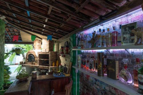 a bar with a bunch of bottles on the wall at Taverna do Paraiso in Janga