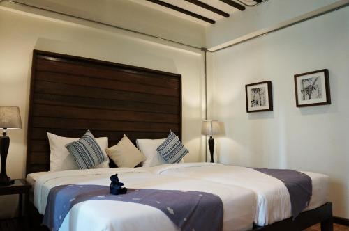 מיטה או מיטות בחדר ב-Kampaeng Ngam Hotel - SHA Extra Plus