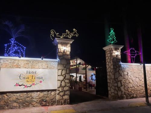 a building with christmas lights and a sign on it at Hotel Casa Lima Bacalar in Bacalar