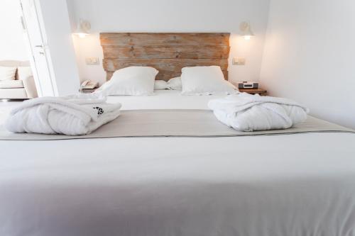 a bedroom with two beds with white sheets and pillows at Hotel Boutique Elvira Plaza in Seville