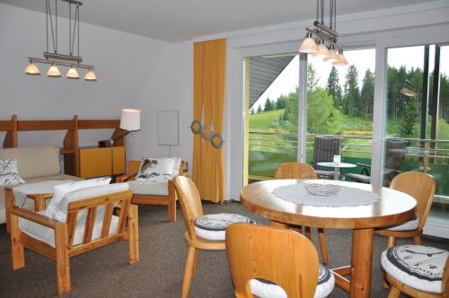 a living room with a table and chairs at Appartements Akzente in Treffen